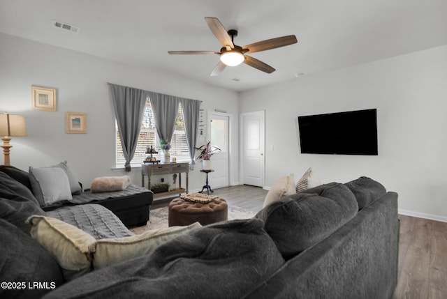 living room featuring light hardwood / wood-style flooring and ceiling fan