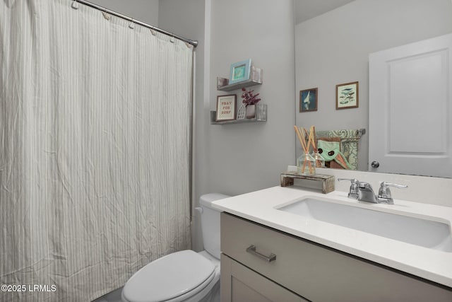 bathroom featuring vanity, walk in shower, and toilet