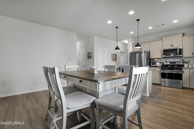 dining room with dark hardwood / wood-style flooring