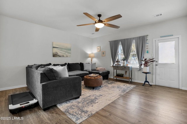 living room with ceiling fan and wood-type flooring