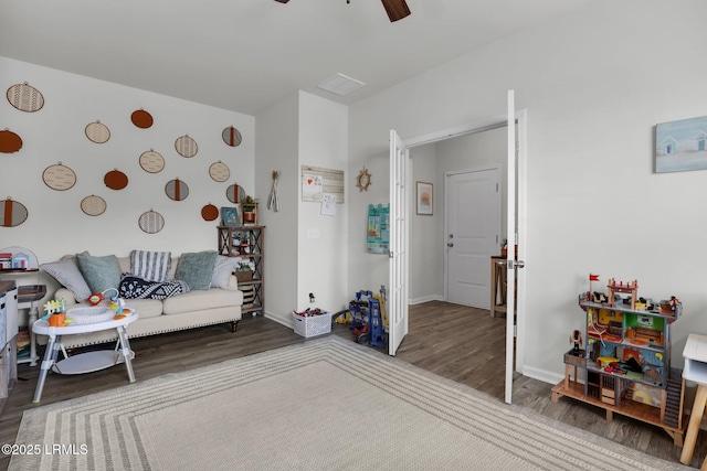 living room featuring hardwood / wood-style flooring and ceiling fan