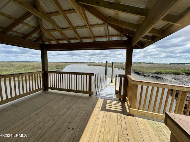 wooden terrace featuring a gazebo and a water view