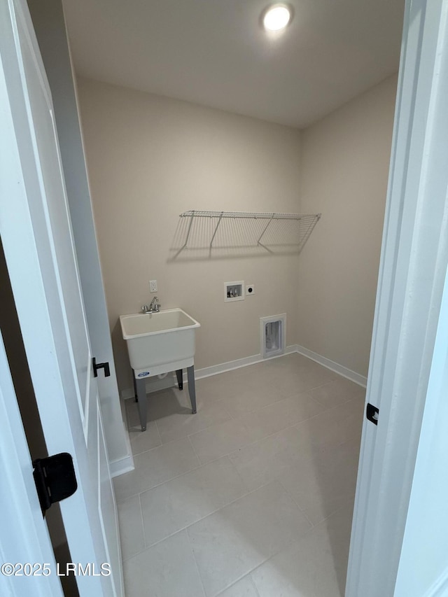 clothes washing area featuring washer hookup, light tile patterned floors, sink, and hookup for an electric dryer