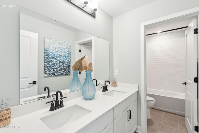 full bathroom featuring tile patterned flooring, vanity, tiled shower / bath combo, and toilet