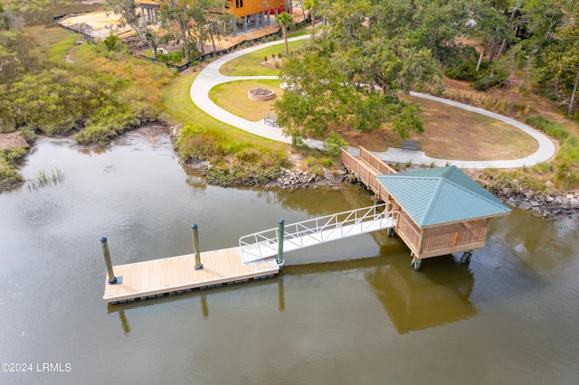 view of dock featuring a water view and a fire pit