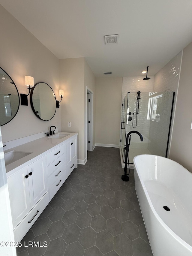 bathroom with tile patterned floors, vanity, and plus walk in shower