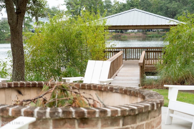 dock area with a gazebo and a water view