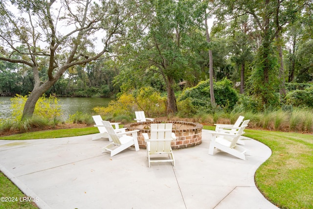 view of patio with a water view and an outdoor fire pit