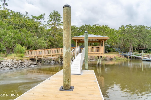 view of dock featuring a gazebo and a water view