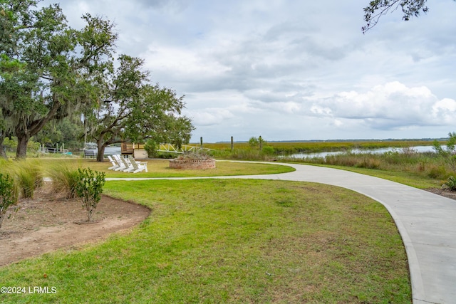 view of community featuring a yard and a water view