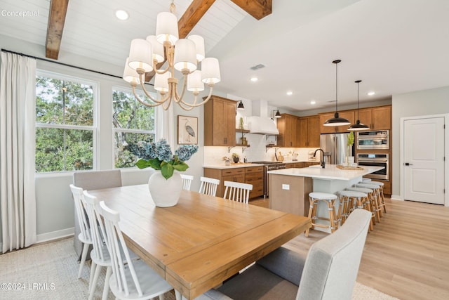 dining room with an inviting chandelier, vaulted ceiling with beams, sink, and light wood-type flooring