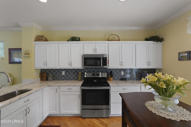 11 Argent Way, Bluffton, SC 29909 - kitchen with appliances with stainless steel finishes, a sink, white cabinetry, ornamental molding, and decorative backsplash