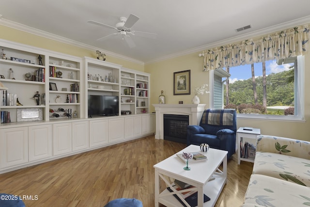 11 Argent Way, Bluffton, SC 29909 - living room featuring crown molding, light wood finished floors, a fireplace, and ceiling fan