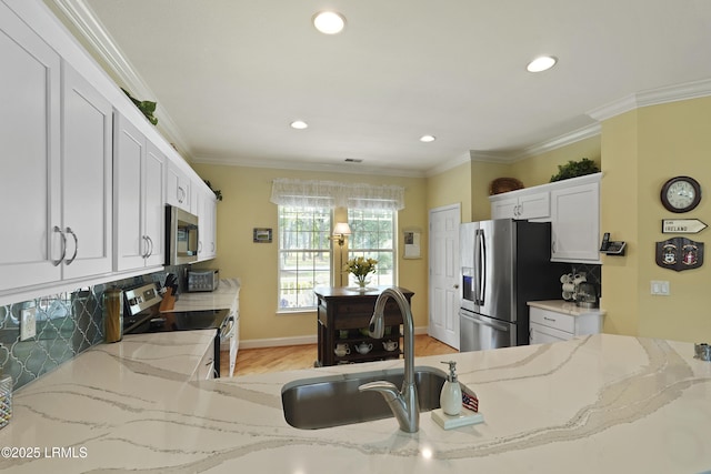 11 Argent Way, Bluffton, SC 29909 - kitchen with stainless steel appliances, light wood-style floors, light stone countertops, backsplash, and white cabinets