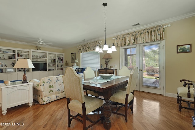 11 Argent Way, Bluffton, SC 29909 - dining space featuring crown molding, wood finished floors, a ceiling fan, a chandelier, and baseboards