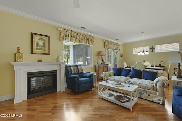 11 Argent Way, Bluffton, SC 29909 - living room with a chandelier, wood finished floors, crown molding, and healthy amount of natural light