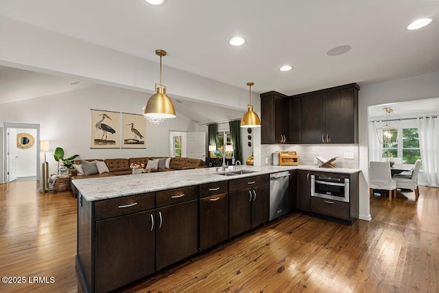 17 Audubon Rd, Ladys Island, SC 29907 - kitchen with open floor plan, lofted ceiling, a peninsula, dark brown cabinets, and dark wood-style flooring