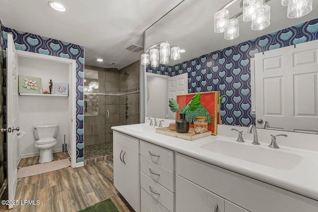 17 Audubon Rd, Ladys Island, SC 29907 - bathroom with wallpapered walls, a shower stall, double vanity, wood finished floors, and recessed lighting