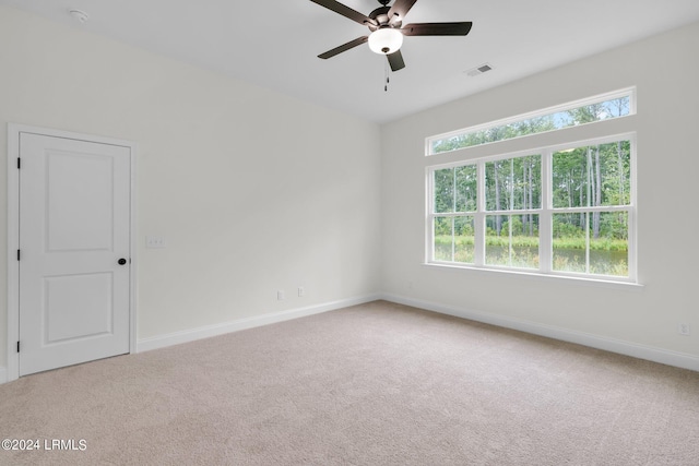 empty room featuring carpet flooring and ceiling fan