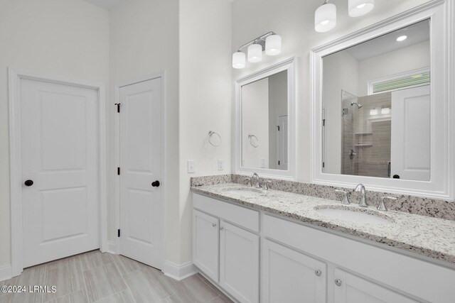 bathroom featuring a tile shower and vanity