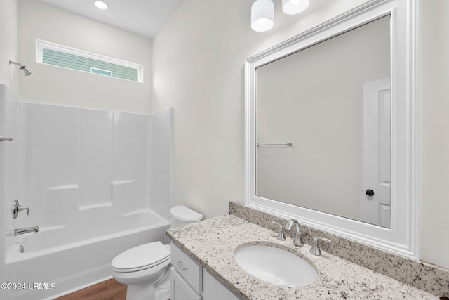 full bathroom with vanity, hardwood / wood-style floors,  shower combination, and toilet