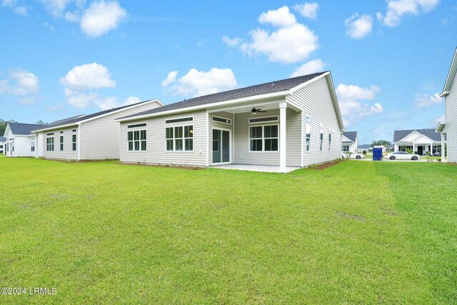 rear view of property with a patio area, ceiling fan, and a lawn