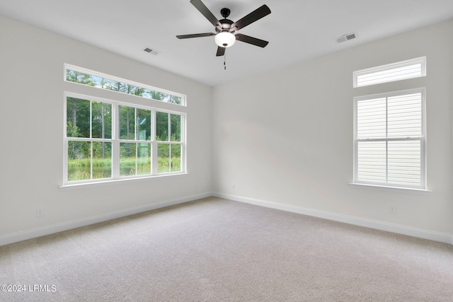 spare room featuring ceiling fan and carpet