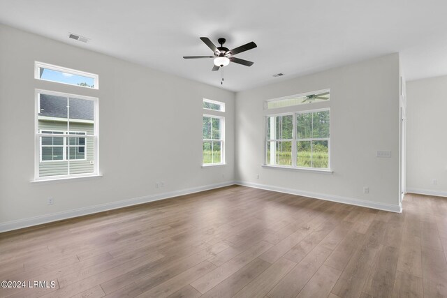 spare room with ceiling fan and light wood-type flooring