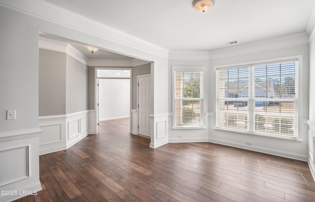 unfurnished living room featuring ornamental molding, plenty of natural light, and dark hardwood / wood-style floors