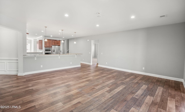 unfurnished living room featuring hardwood / wood-style flooring