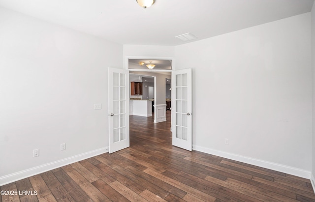 unfurnished room featuring dark hardwood / wood-style flooring and french doors