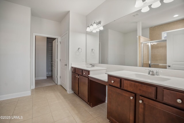 bathroom with vanity, tile patterned flooring, and a shower with door