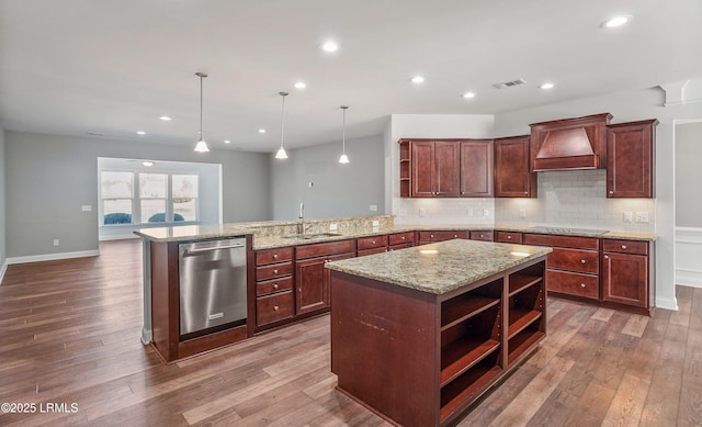 kitchen featuring premium range hood, sink, hanging light fixtures, dishwasher, and kitchen peninsula