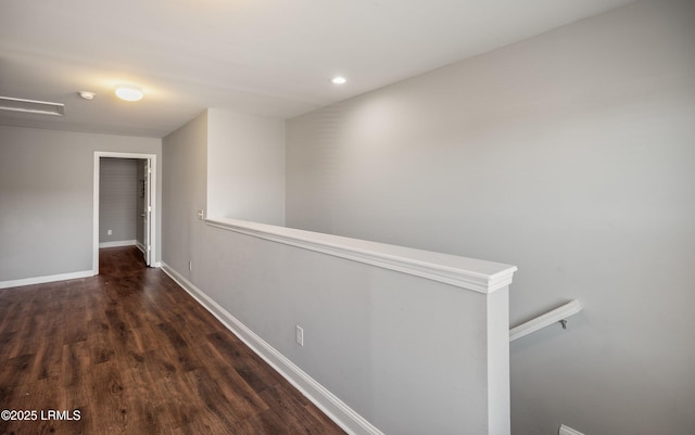 corridor with dark hardwood / wood-style flooring