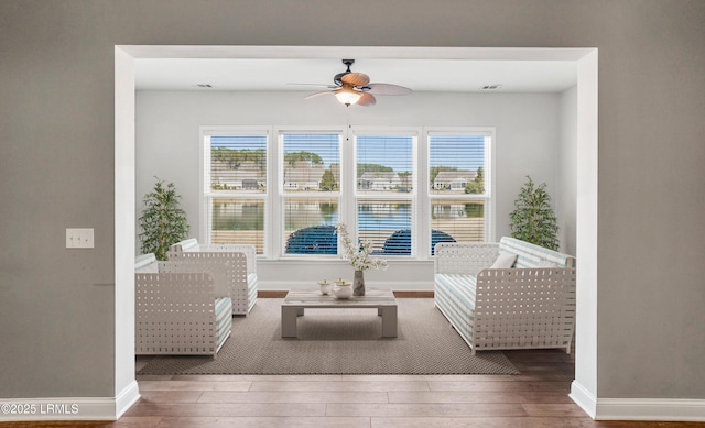 living room with hardwood / wood-style flooring and ceiling fan