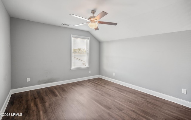 spare room featuring dark wood-type flooring, ceiling fan, and lofted ceiling