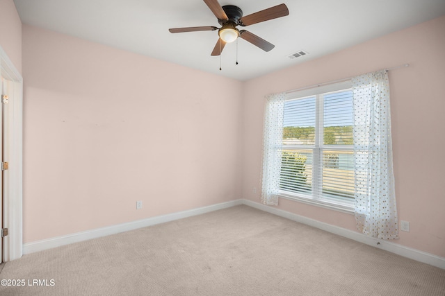 carpeted spare room featuring ceiling fan