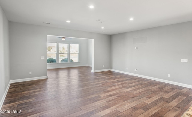 spare room with dark wood-type flooring and ceiling fan