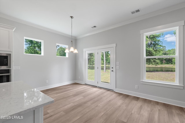41 Fairfield Rd, Beaufort, SC 29907 - unfurnished dining area featuring visible vents, a healthy amount of sunlight, and light wood-style floors