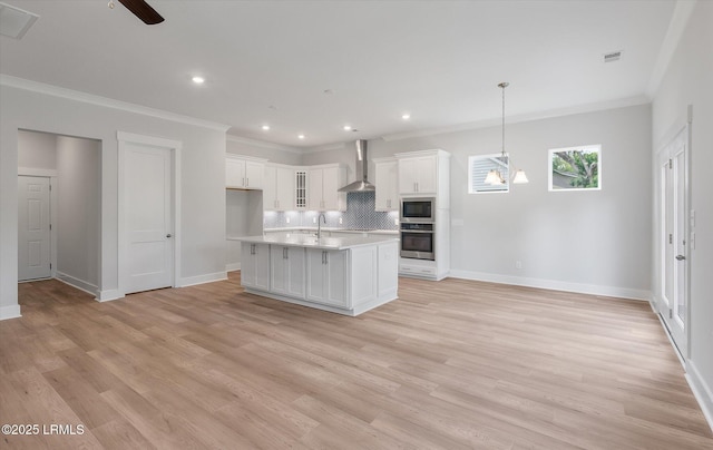41 Fairfield Rd, Beaufort, SC 29907 - kitchen featuring wall chimney range hood, decorative backsplash, appliances with stainless steel finishes, light countertops, and ornamental molding