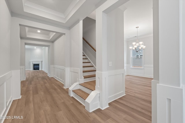 41 Fairfield Rd, Beaufort, SC 29907 - corridor featuring stairway, ornamental molding, a decorative wall, and light wood-type flooring