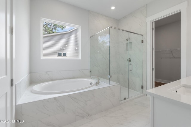 41 Fairfield Rd, Beaufort, SC 29907 - bathroom featuring a spacious closet, a marble finish shower, marble finish floor, and a garden tub