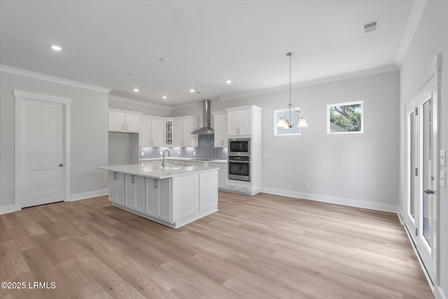 41 Fairfield Rd, Beaufort, SC 29907 - kitchen with wall chimney range hood, oven, a sink, built in microwave, and visible vents