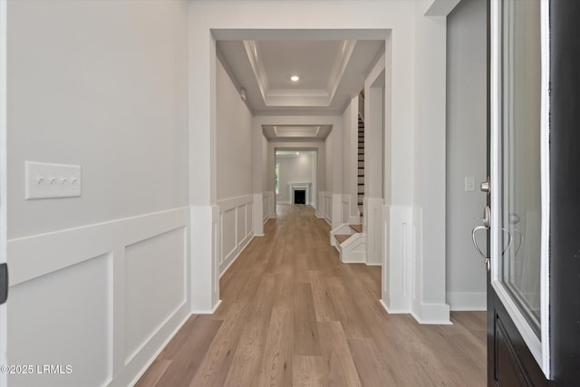 41 Fairfield Rd, Beaufort, SC 29907 - corridor featuring crown molding, light wood-type flooring, a raised ceiling, a wainscoted wall, and a decorative wall