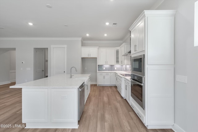 41 Fairfield Rd, Beaufort, SC 29907 - kitchen with appliances with stainless steel finishes, a sink, light wood finished floors, backsplash, and ornamental molding