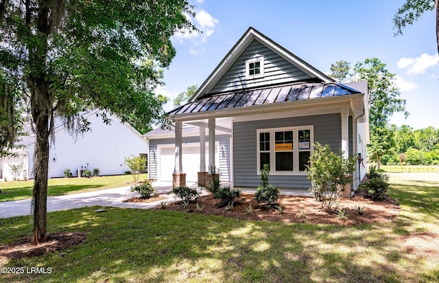 41 Fairfield Rd, Beaufort, SC 29907 - view of front of property featuring a front yard, metal roof, a standing seam roof, concrete driveway, and an attached garage