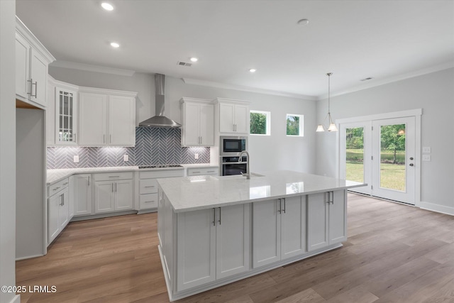 41 Fairfield Rd, Beaufort, SC 29907 - kitchen with crown molding, appliances with stainless steel finishes, tasteful backsplash, white cabinets, and wall chimney exhaust hood