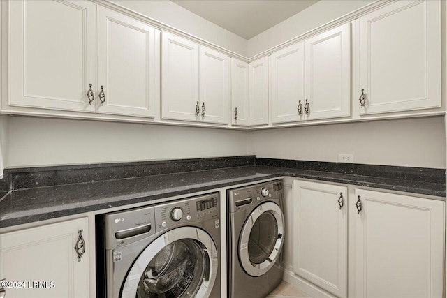 washroom featuring cabinets and separate washer and dryer