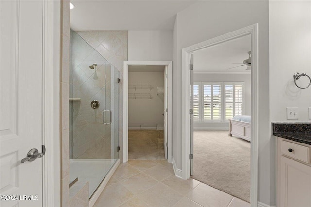 bathroom featuring an enclosed shower, ornamental molding, vanity, ceiling fan, and tile patterned flooring