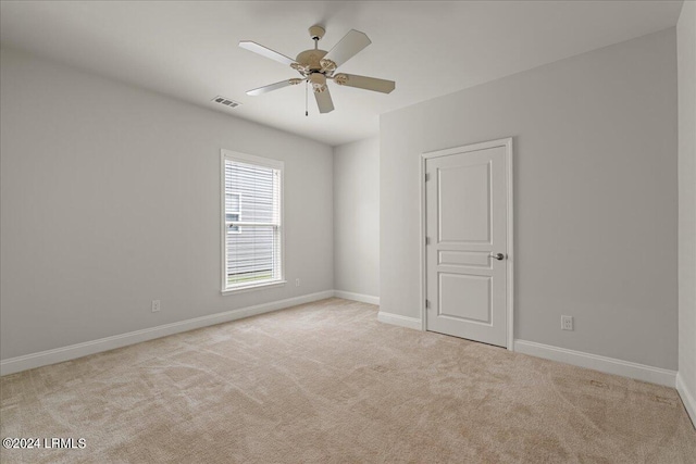 spare room with light carpet and ceiling fan